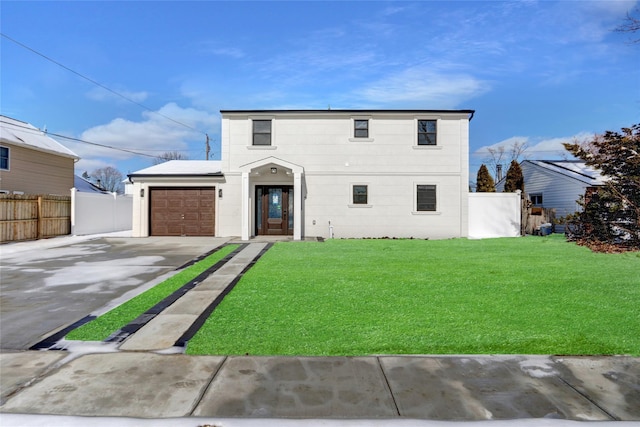 view of front of home with a garage and a front lawn