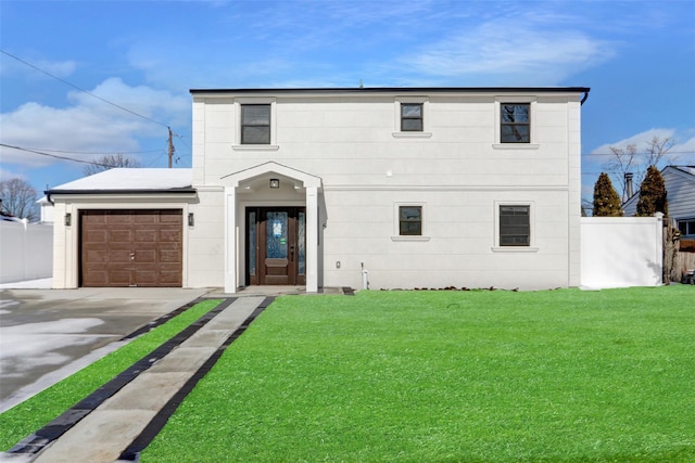 view of front facade with a garage and a front lawn