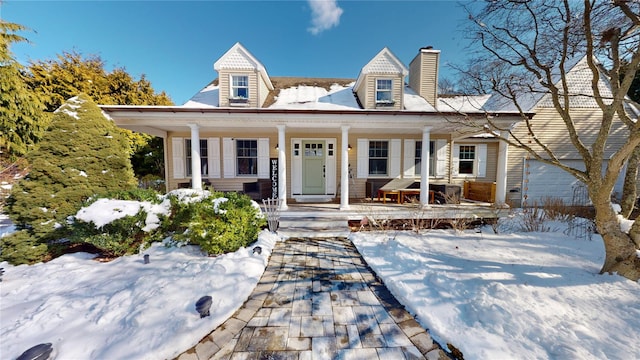 cape cod house featuring a porch