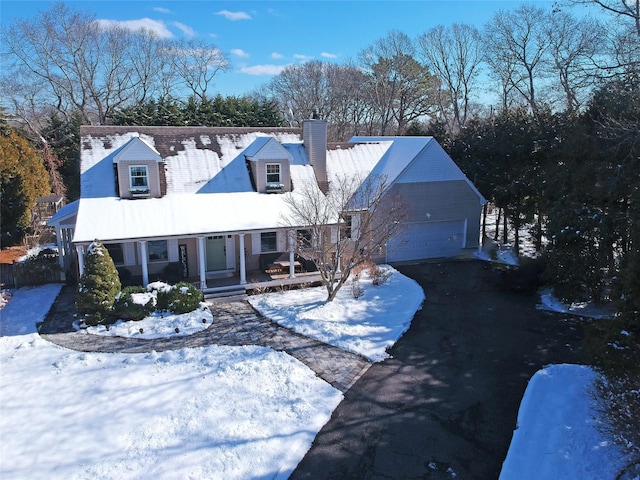 cape cod-style house with a porch and a garage