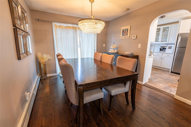 dining room with a baseboard radiator, dark wood-type flooring, and an inviting chandelier