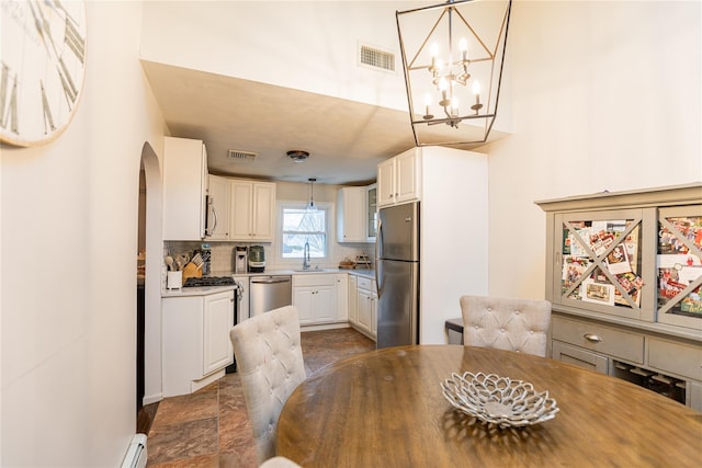 dining space with an inviting chandelier and sink