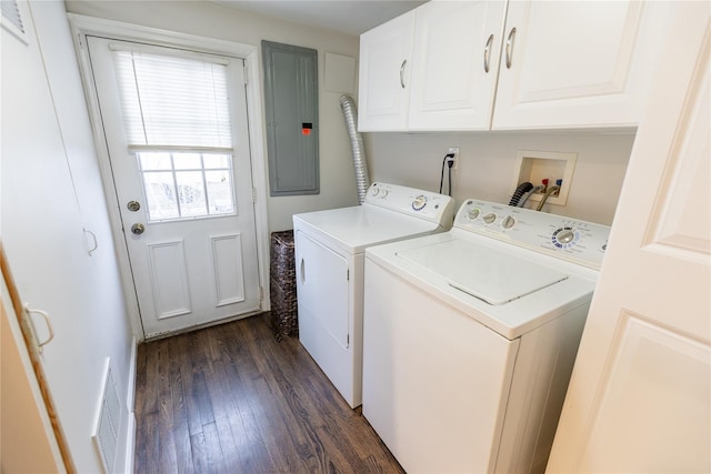 washroom with washer and dryer, dark hardwood / wood-style floors, electric panel, and cabinets