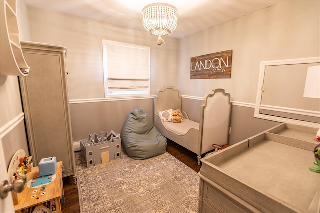 bedroom featuring dark wood-type flooring and a chandelier