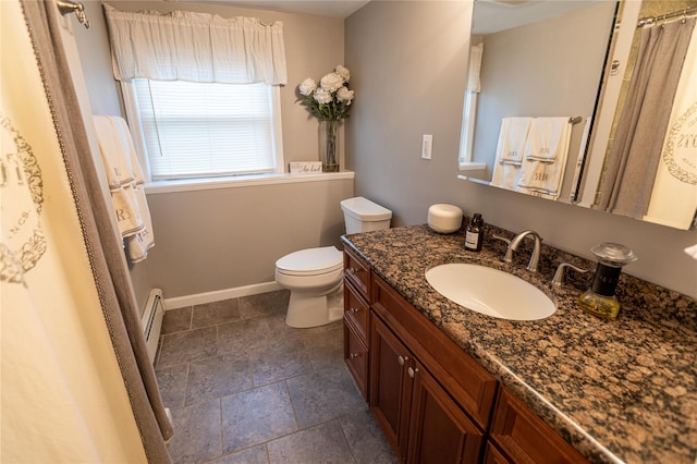 bathroom featuring baseboard heating, vanity, and toilet