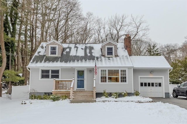 cape cod home with a garage