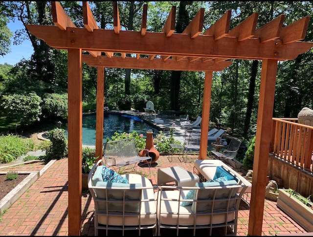 view of patio with a swimming pool and a pergola