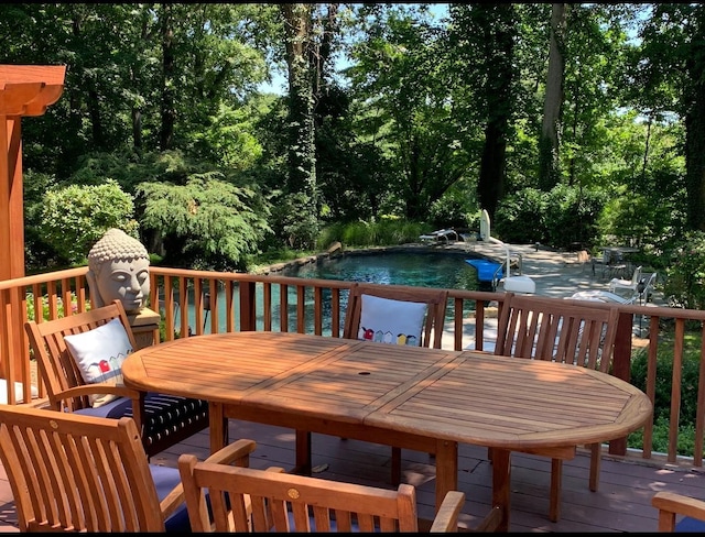 wooden terrace with an outdoor pool, a patio area, and outdoor dining area