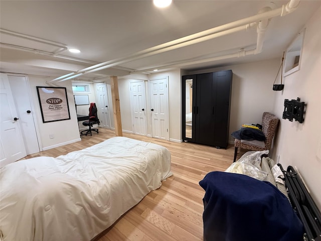 bedroom featuring wood finished floors and recessed lighting