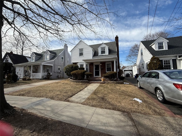 204 N Grove St, Valley Stream, NY 11580 - new england style home with a chimney, brick siding, a residential view, and a porch