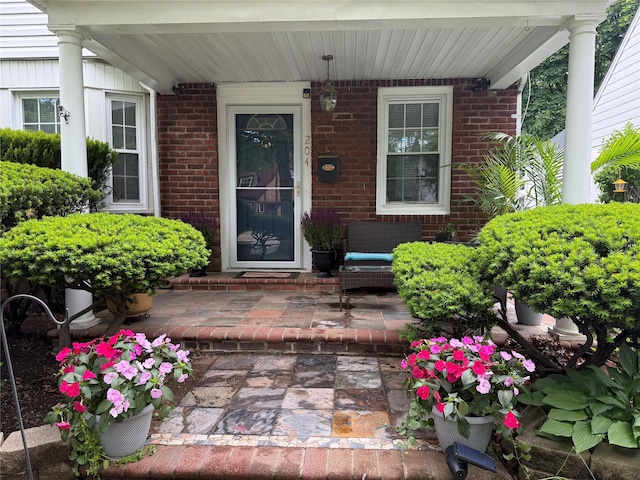 204 N Grove St, Valley Stream, NY 11580 - view of exterior entry featuring brick siding and covered porch