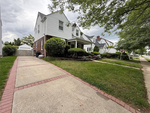 204 N Grove St, Valley Stream, NY 11580 - view of front of property with brick siding, a front lawn, an outbuilding, and a detached garage