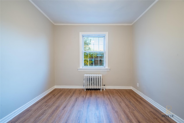 unfurnished room with radiator, ornamental molding, and hardwood / wood-style floors