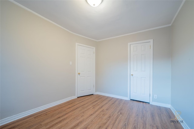 unfurnished room with ornamental molding and hardwood / wood-style floors