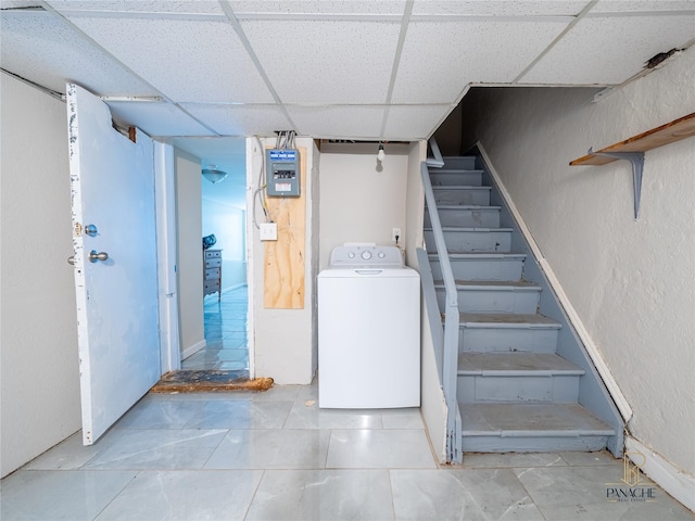 interior space featuring washer / dryer and a drop ceiling