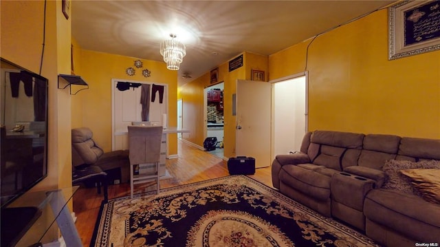 living room featuring an inviting chandelier and light wood-type flooring