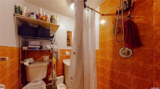 bathroom with tile walls, toilet, and walk in shower