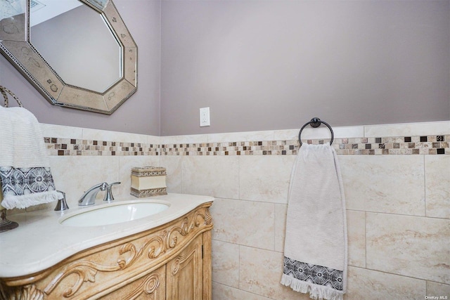 bathroom with vanity and tile walls