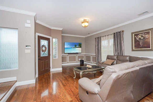 living room featuring wood-type flooring and ornamental molding