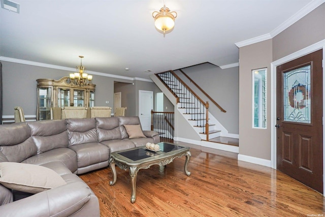 living room featuring crown molding, hardwood / wood-style floors, and a notable chandelier