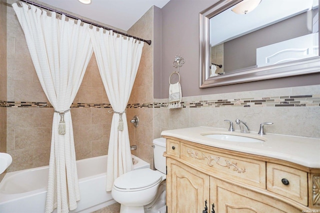 full bathroom featuring vanity, tile walls, shower / bathtub combination with curtain, and toilet