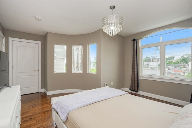 bedroom featuring dark hardwood / wood-style floors and a notable chandelier