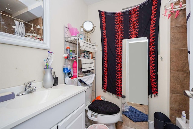 bathroom with a shower with shower curtain, vanity, toilet, and tile patterned flooring