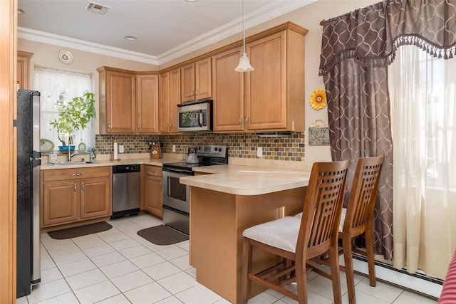 kitchen with stainless steel appliances, light countertops, ornamental molding, decorative backsplash, and decorative light fixtures