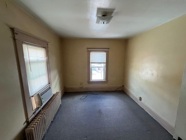 empty room with radiator and carpet floors