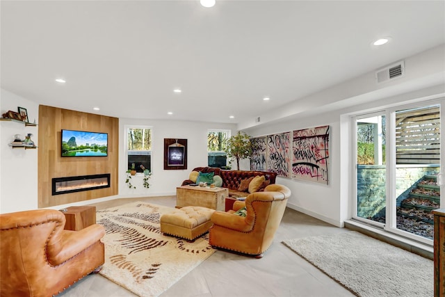 living room featuring a large fireplace