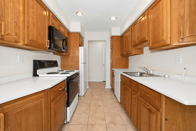 kitchen featuring white appliances, sink, and light tile patterned flooring