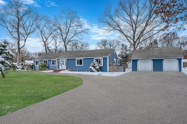 ranch-style house featuring a garage, an outdoor structure, and a front yard