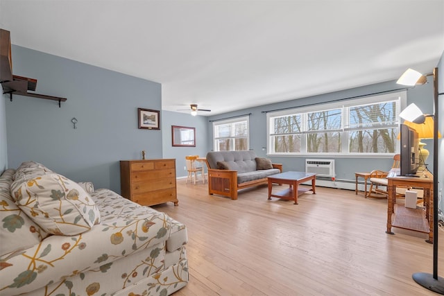 bedroom with a wall unit AC, light hardwood / wood-style floors, ceiling fan, and baseboard heating