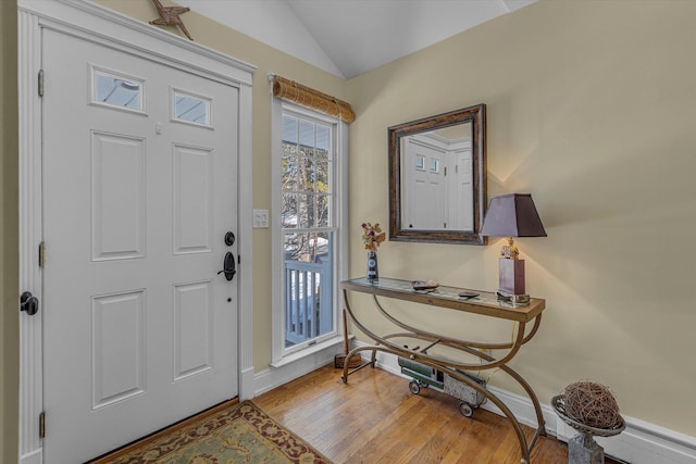 foyer with lofted ceiling and light hardwood / wood-style floors