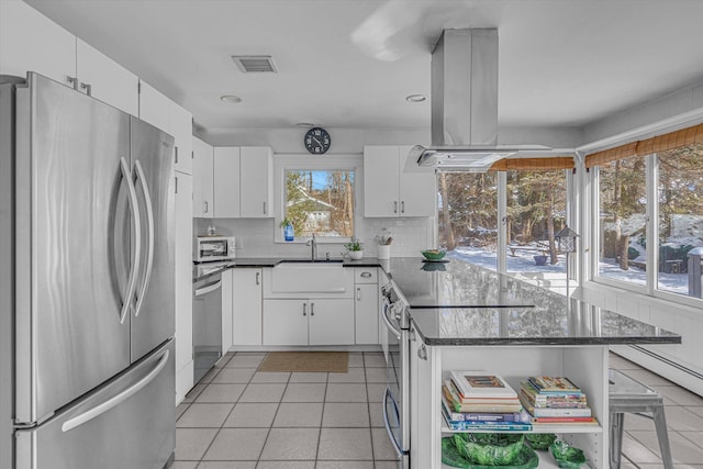 kitchen featuring sink, white cabinetry, light tile patterned floors, appliances with stainless steel finishes, and island exhaust hood