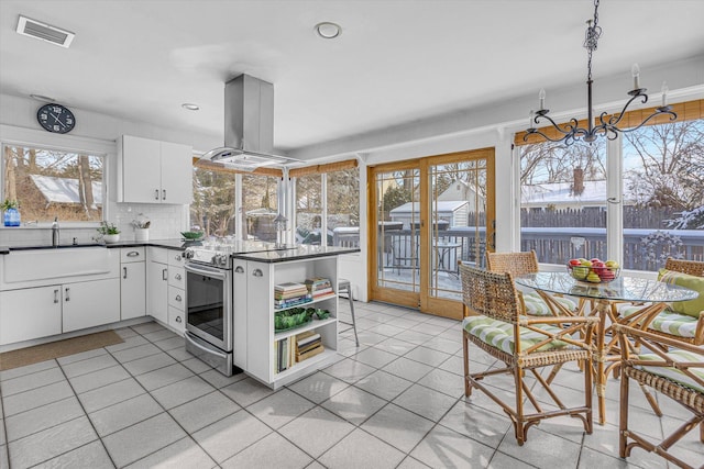 kitchen with sink, stainless steel range with electric cooktop, white cabinetry, island range hood, and light tile patterned floors