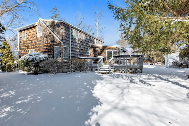 snow covered house with a deck