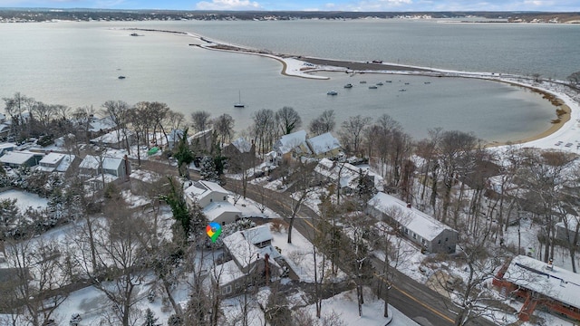 snowy aerial view with a water view