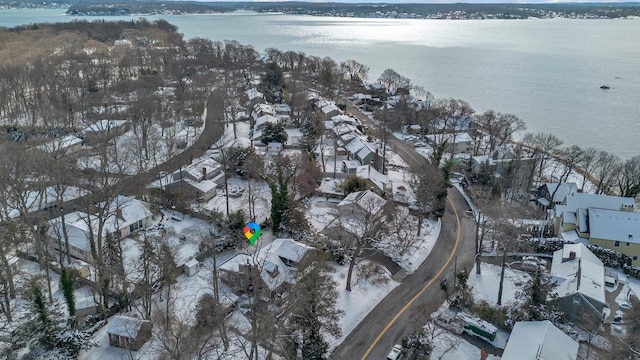 snowy aerial view featuring a water view