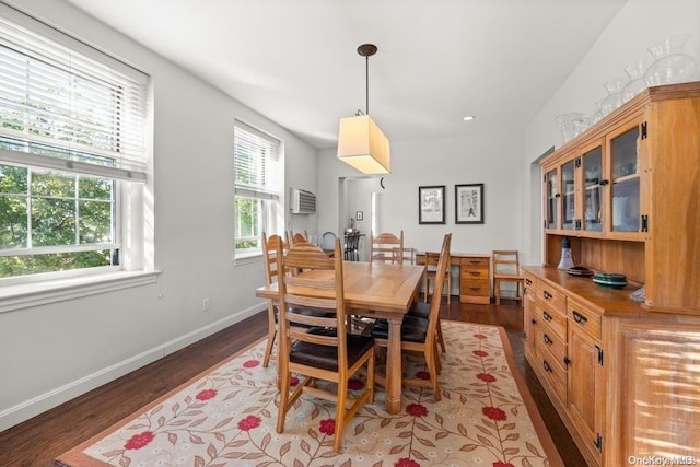 dining room featuring a wall mounted air conditioner and dark hardwood / wood-style floors