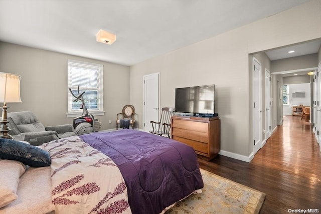 bedroom featuring dark hardwood / wood-style flooring and multiple windows