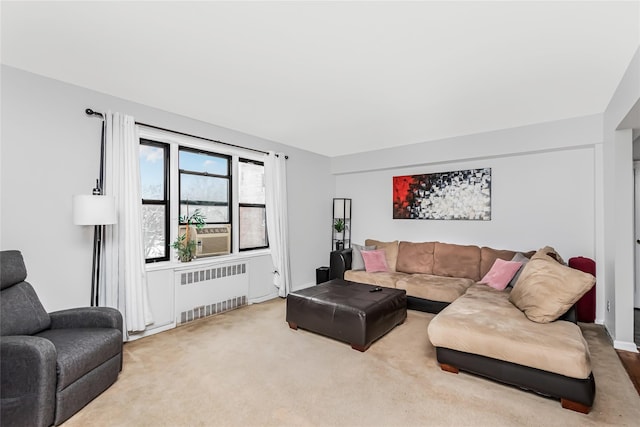 carpeted living room with cooling unit and radiator heating unit