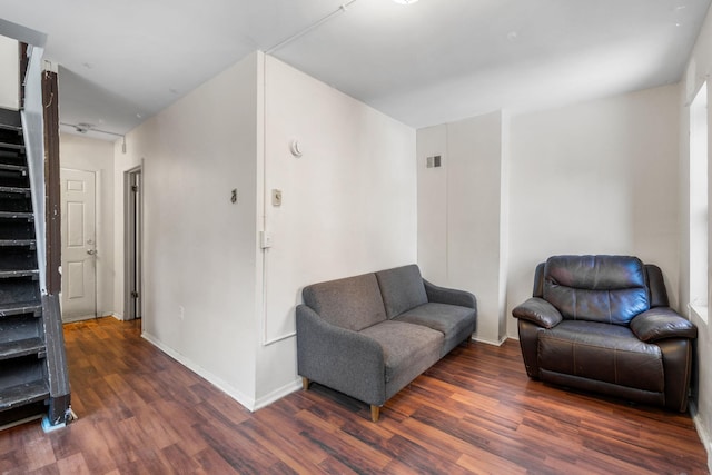 living room with dark hardwood / wood-style flooring