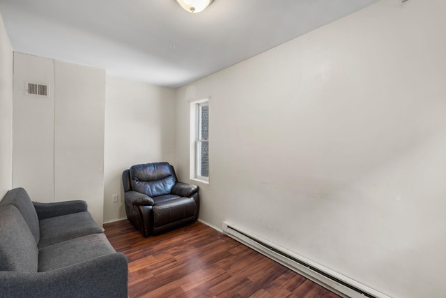 living area featuring dark wood-type flooring and a baseboard radiator