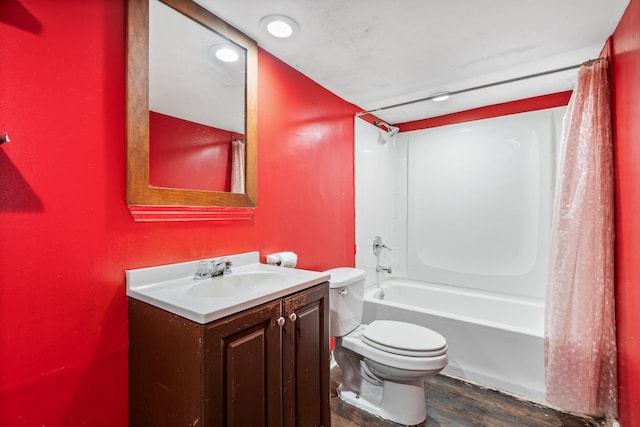 full bathroom featuring shower / tub combo with curtain, vanity, hardwood / wood-style floors, and toilet