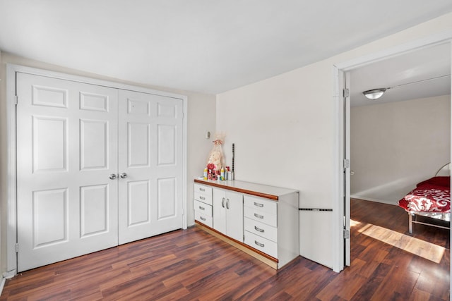 bedroom with a closet and dark hardwood / wood-style floors