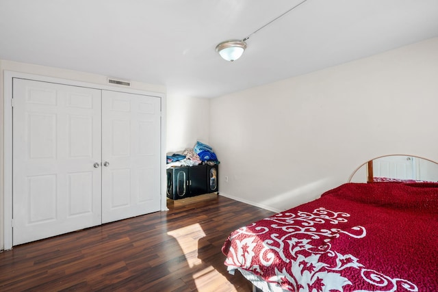 bedroom featuring a closet and dark hardwood / wood-style floors