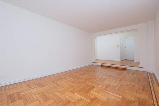 spare room featuring baseboards