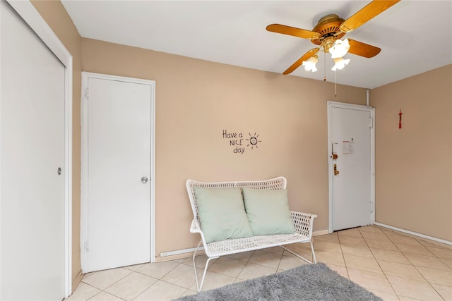 unfurnished room featuring ceiling fan and light tile patterned floors