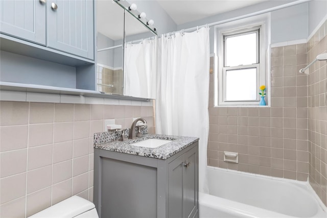 209-20 18th Ave Unit 6C, Bayside, NY 11360 - bathroom featuring tile walls, vanity, shower / bath combo with shower curtain, and toilet
